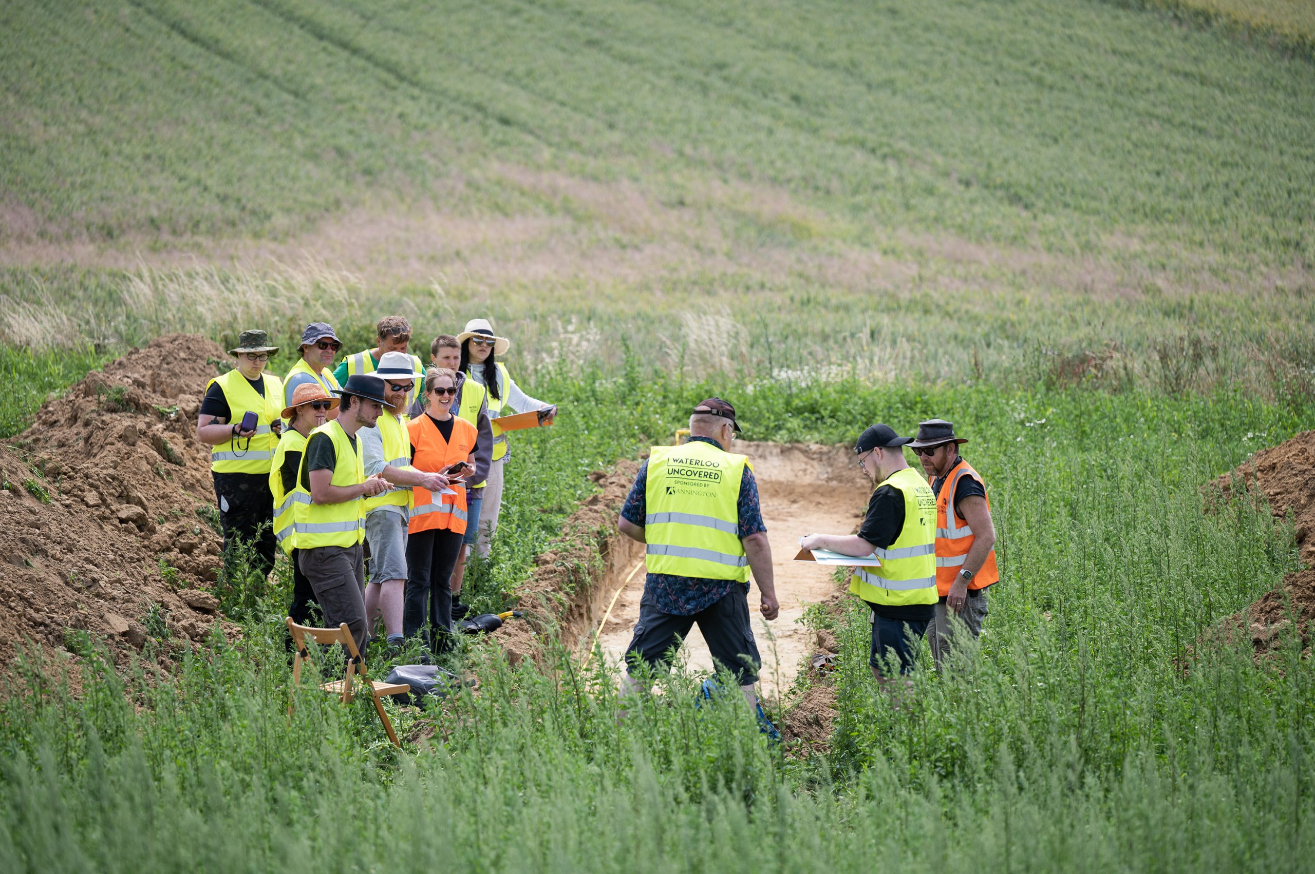 Veterans-archaeologists-and-students-examining-a-trench-©chrisvanhouts-scaled